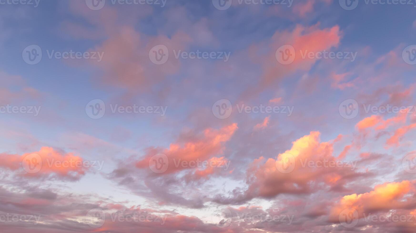 Colorful orange-purple dramatic clouds lit by the setting sun against the evening sky. photo