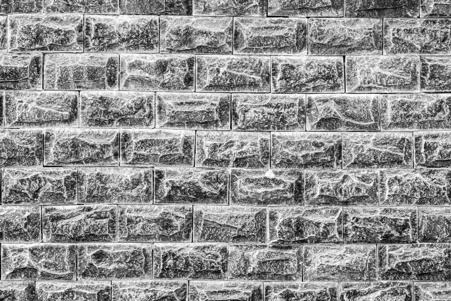 Black and white texture of a wall covered with decorative brick-like tiles. Abstract background for design. photo