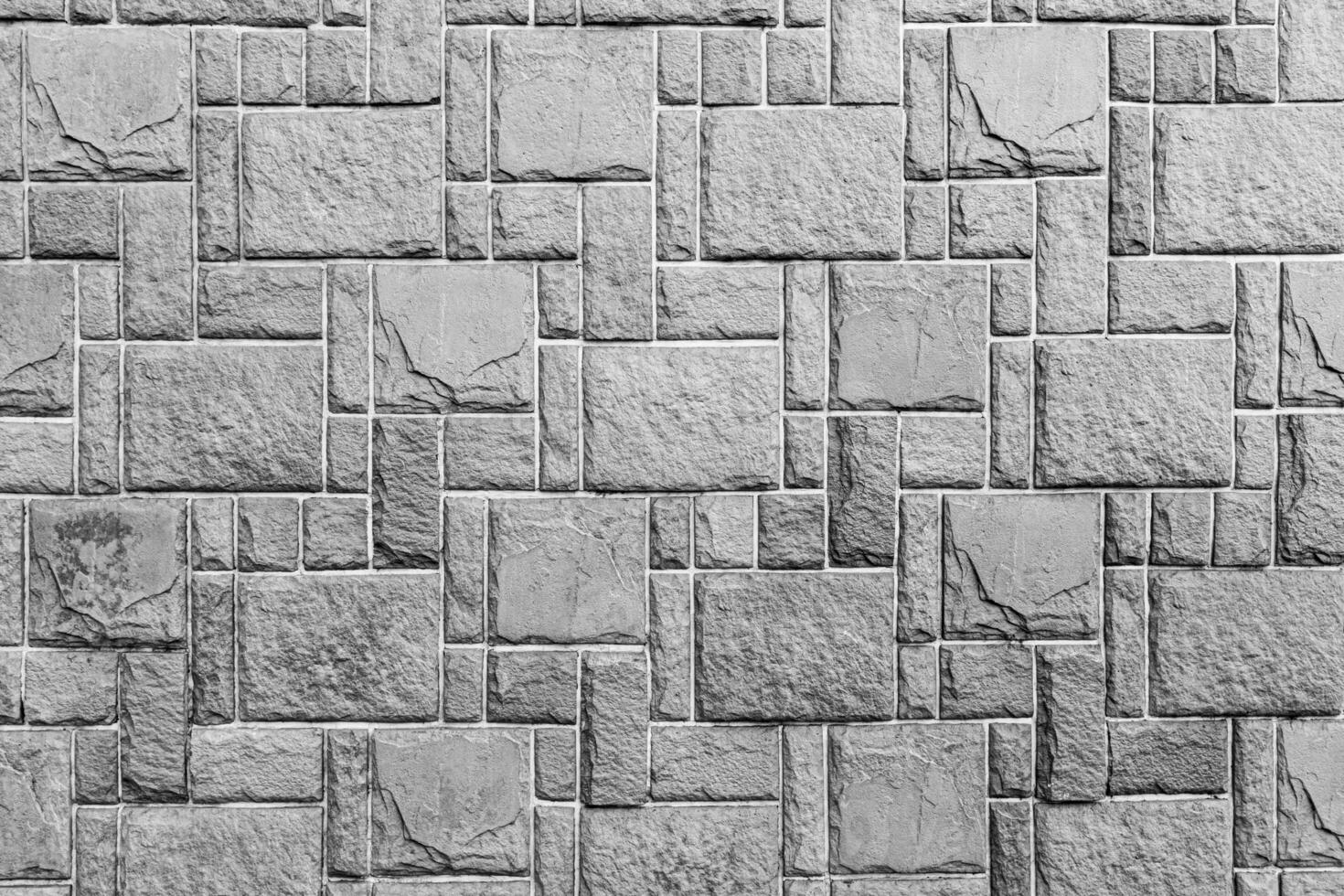 Black and white texture of a wall covered with decorative brick-like tiles. Abstract background for design. photo