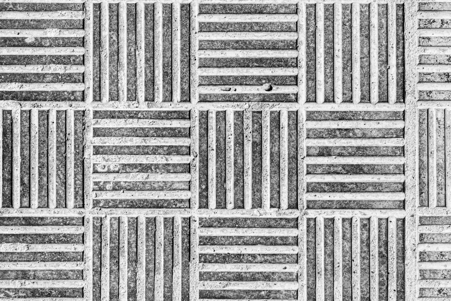 Top view on paving stone road. Old pavement of concrete texture. Cobblestone sidewalk. Black and white abstract background for design. photo