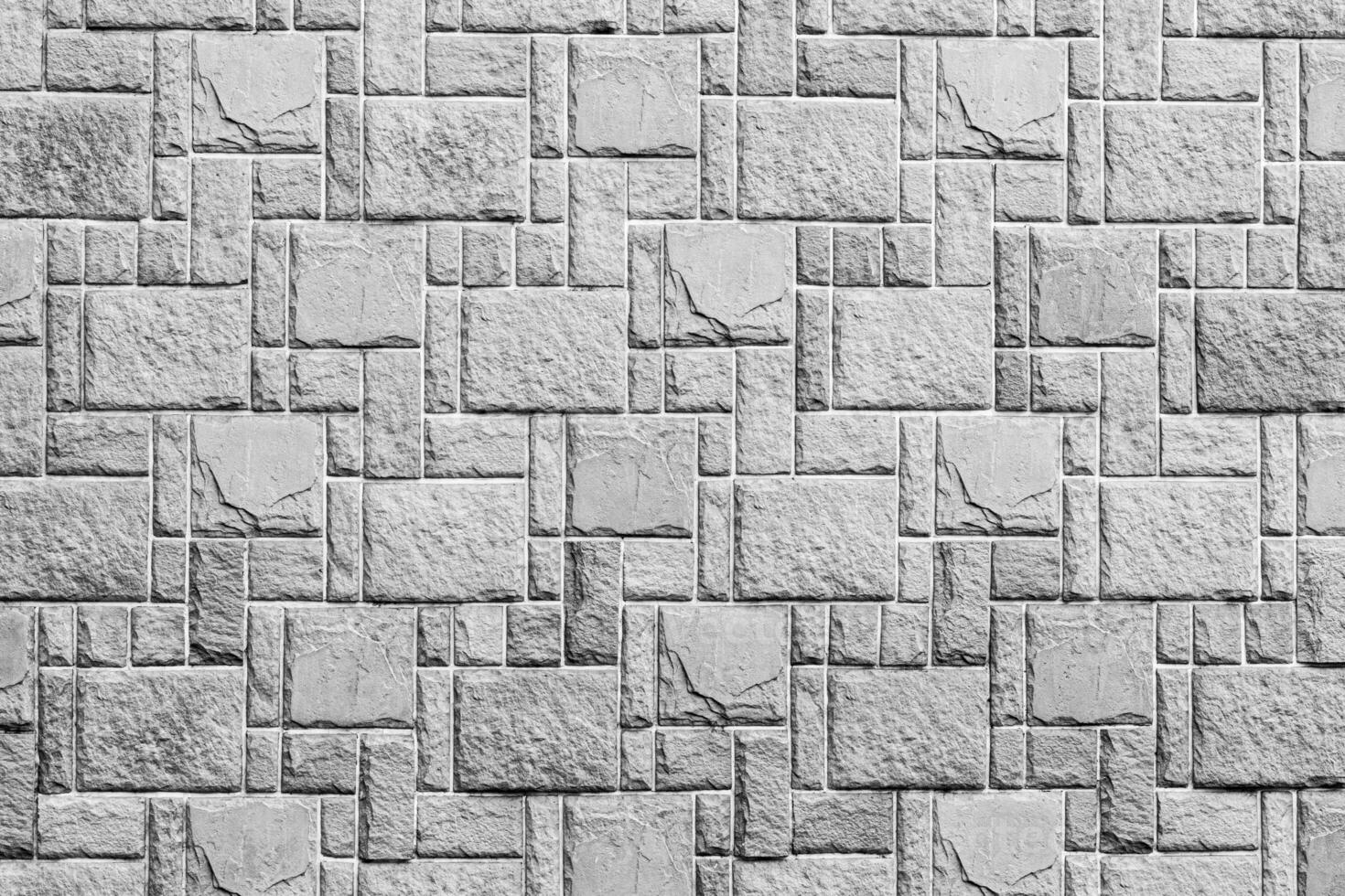 Black and white texture of a wall covered with decorative brick-like tiles. Abstract background for design. photo