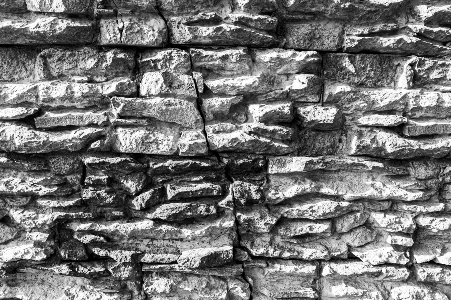 Black and white texture of a wall covered with decorative brick-like tiles. Abstract background for design. photo