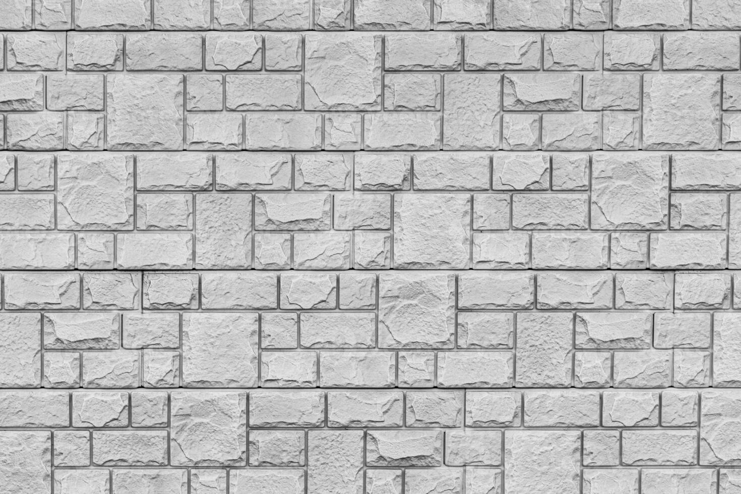 Black and white texture of a wall covered with decorative brick-like tiles. Abstract background for design. photo