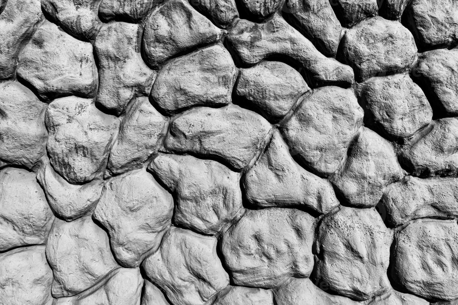Black and white texture of a wall made of stones. Abstract background. photo
