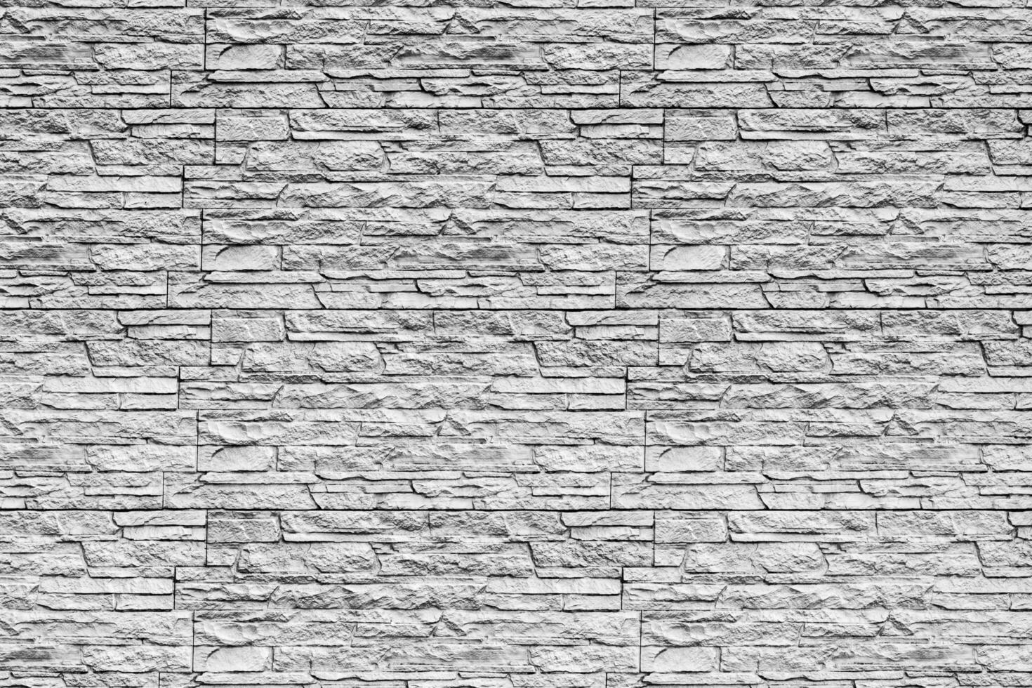Black and white texture of a wall covered with decorative brick-like tiles. Abstract background for design. photo