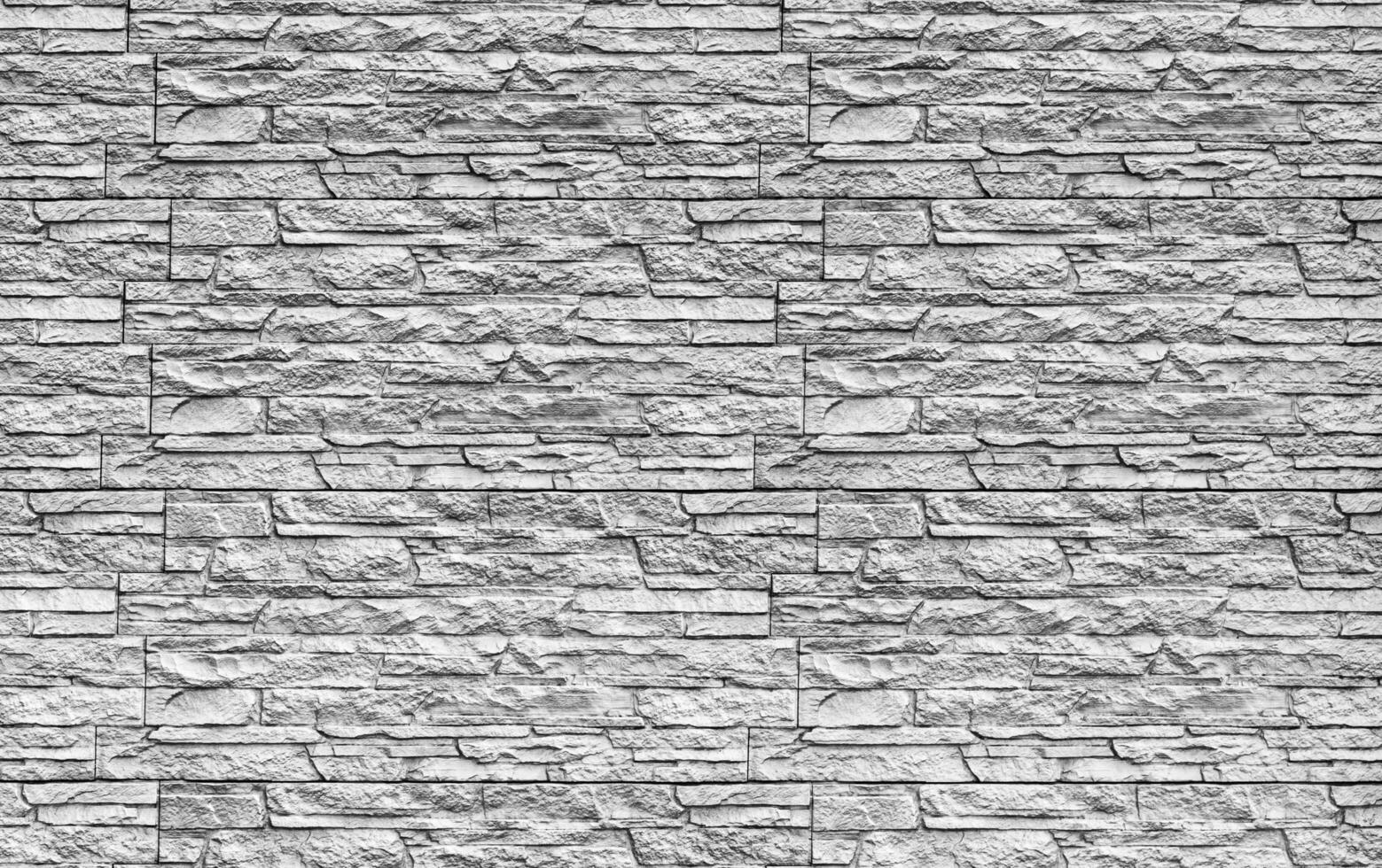 Black and white texture of a wall covered with decorative brick-like tiles. Abstract background for design. photo