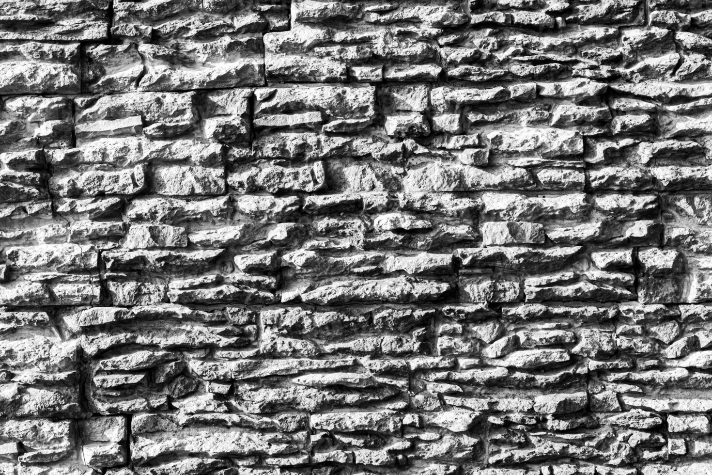 Black and white texture of a wall covered with decorative brick-like tiles. Abstract background for design. photo