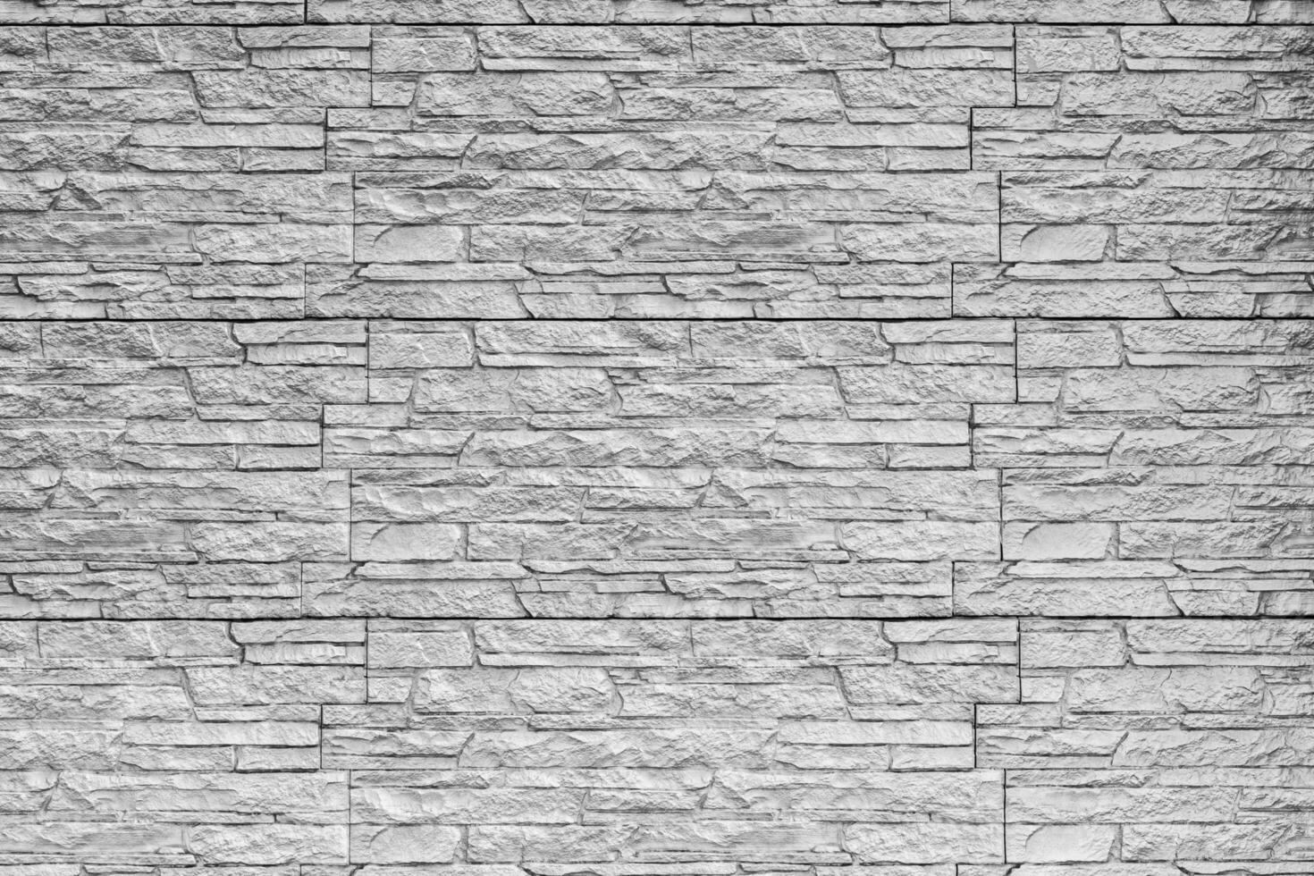 Black and white texture of a wall covered with decorative brick-like tiles. Abstract background for design. photo