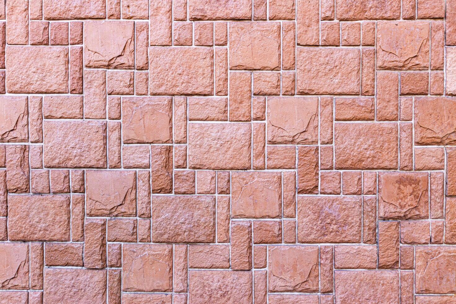 Texture of a wall covered with decorative brick-like tiles. Abstract background for design. photo