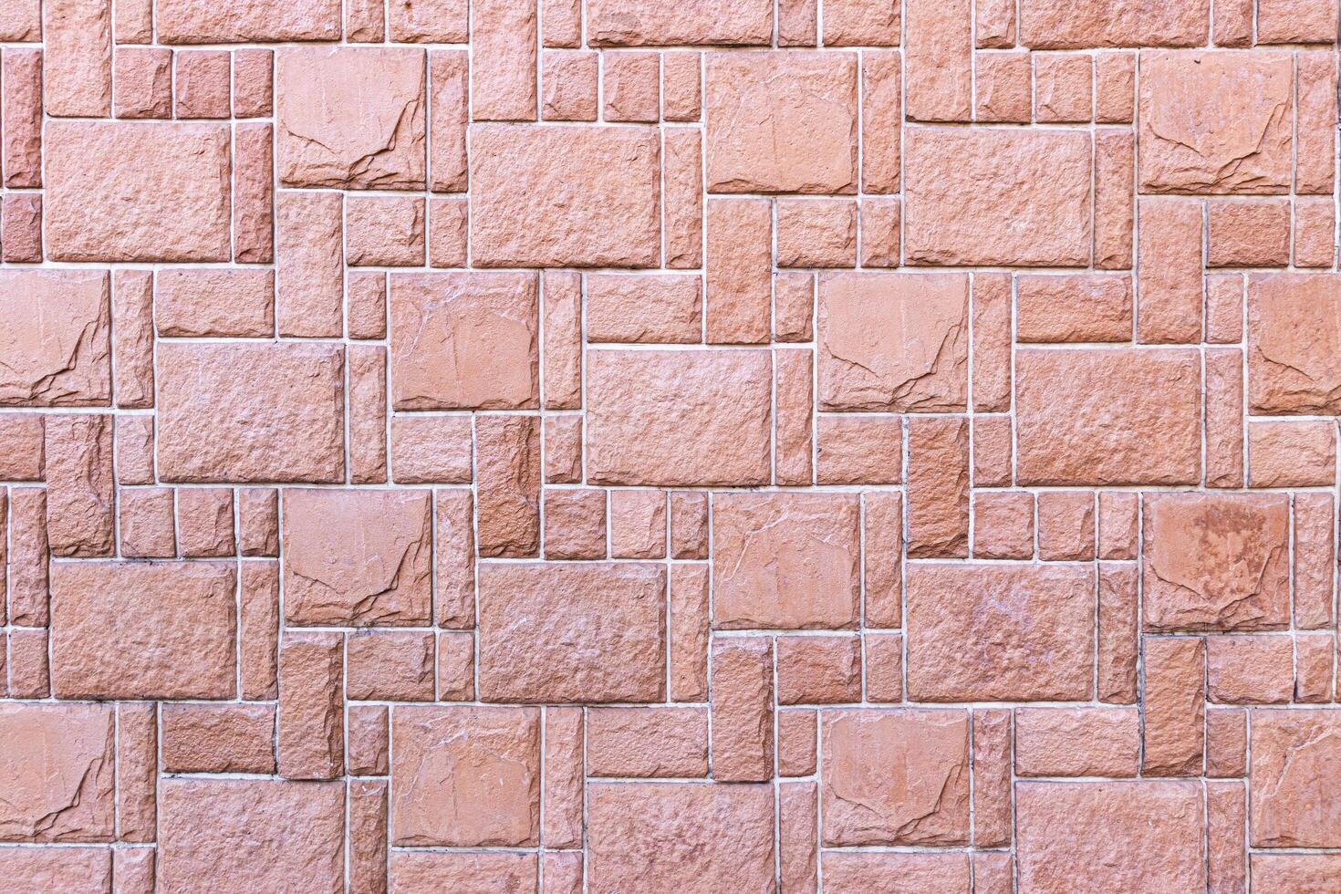 Texture of a wall covered with decorative brick-like tiles. Abstract background for design. photo