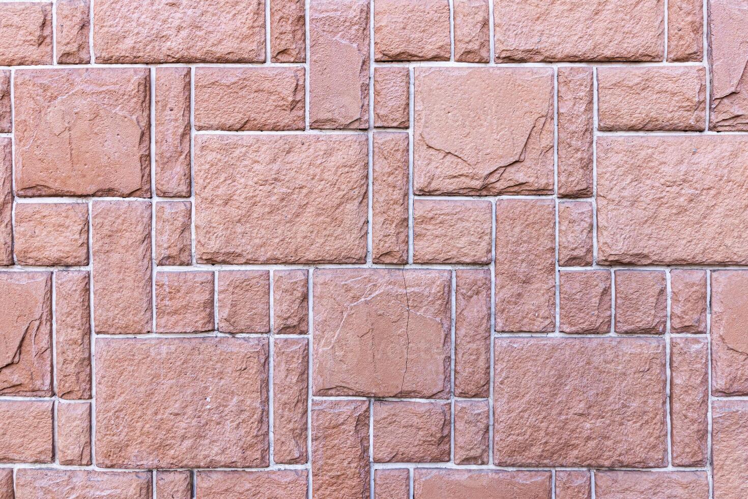 Texture of a wall covered with decorative brick-like tiles. Abstract background for design. photo