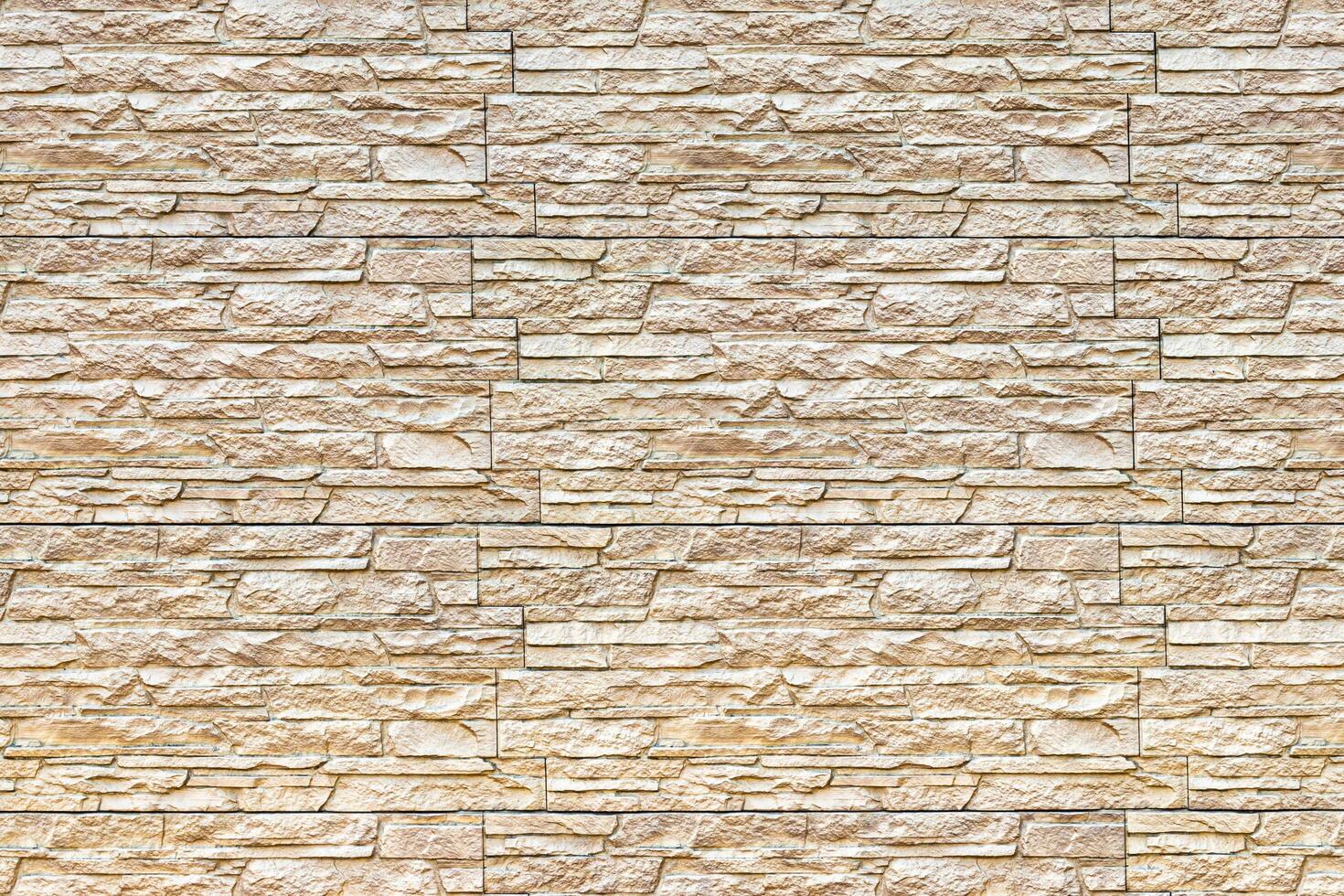 Texture of a wall covered with decorative brick-like tiles. Abstract background for design. photo