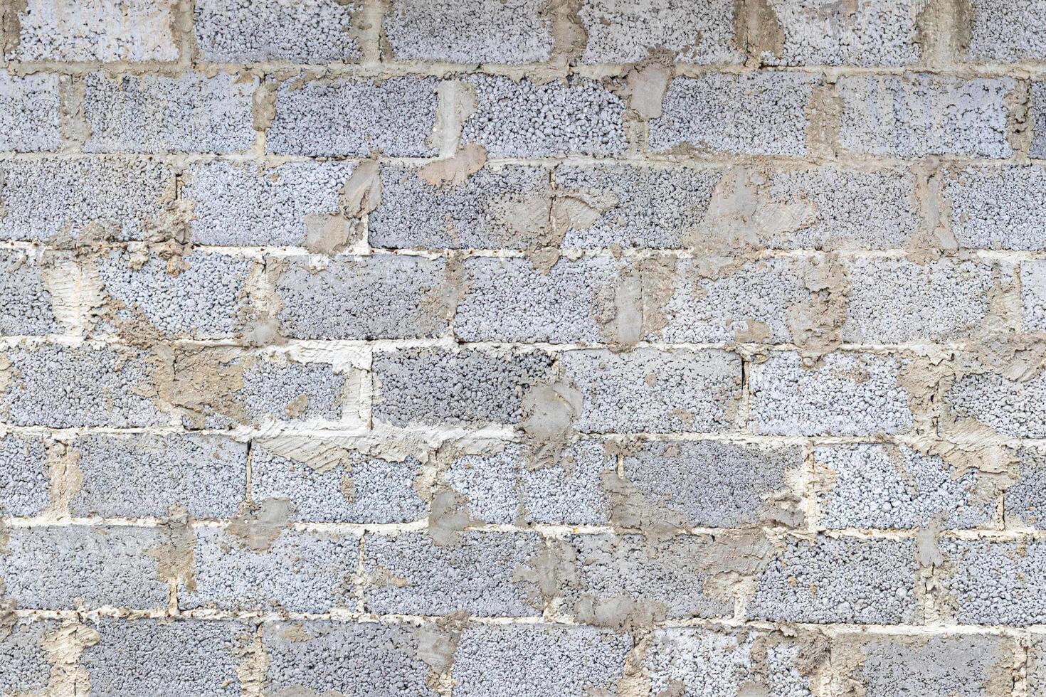 Monochrome texture of a wall made of concrete blocks connected cement. Abstract background. photo