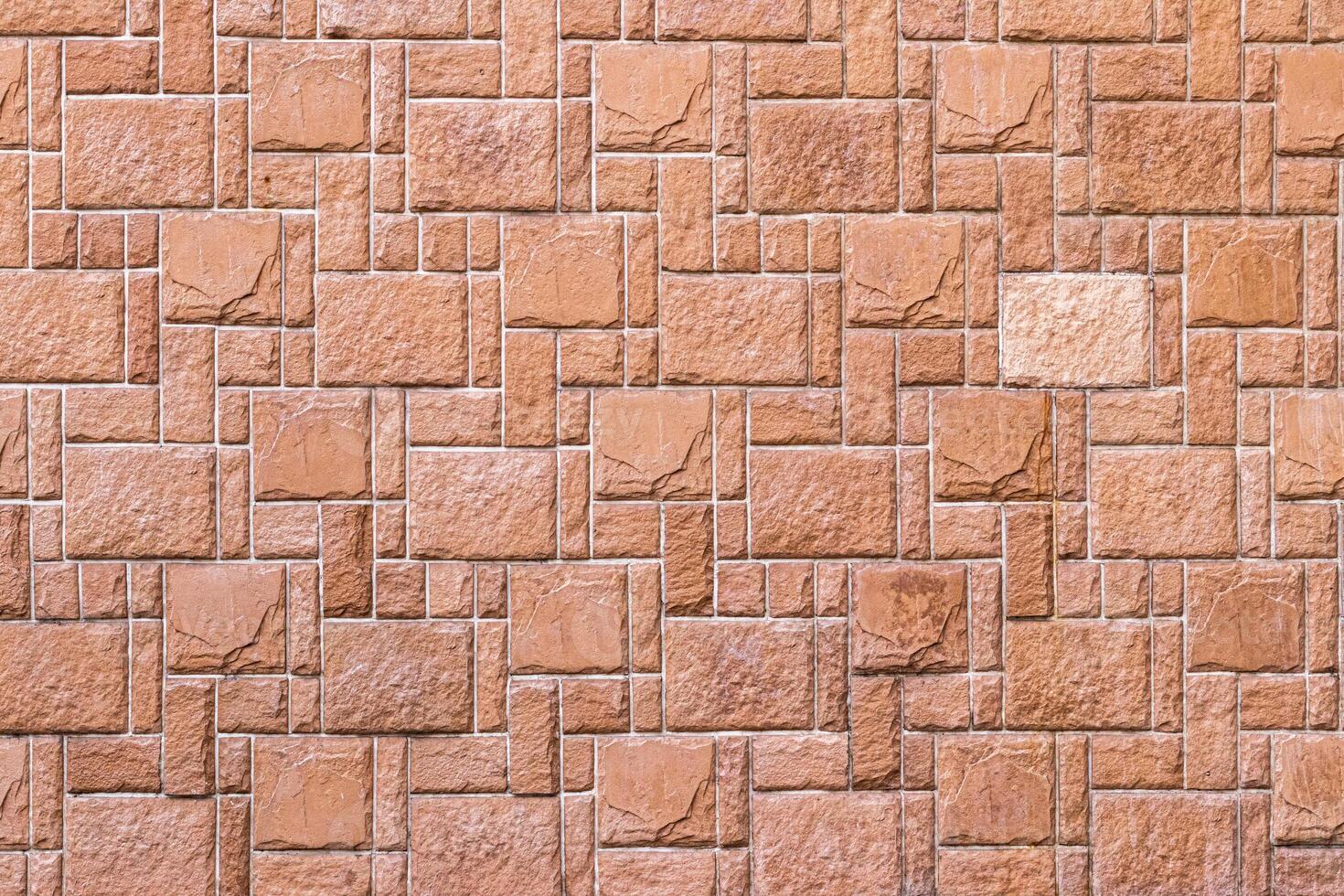 Texture of a wall covered with decorative brick-like tiles. Abstract background for design. photo