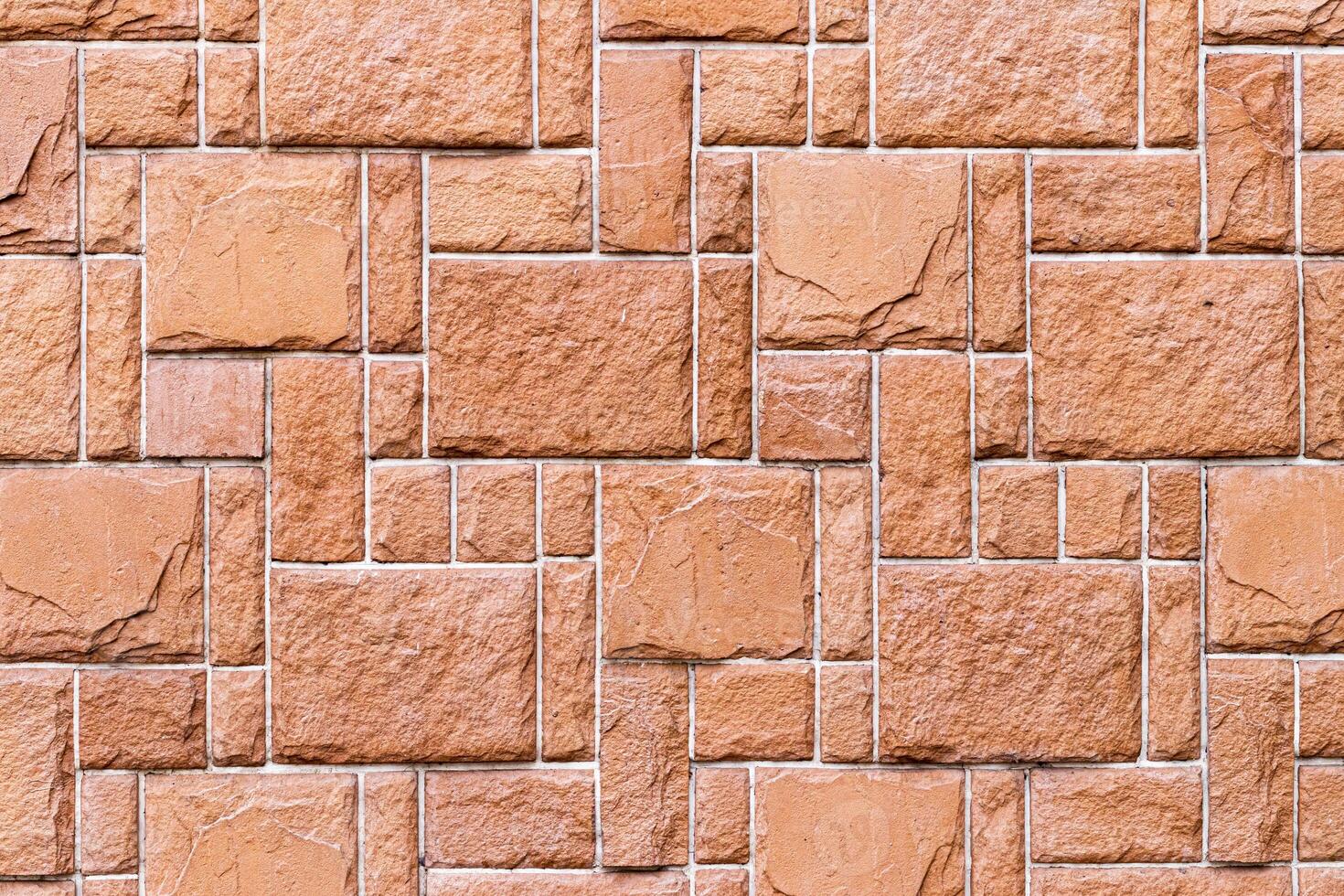 Texture of a wall covered with decorative brick-like tiles. Abstract background for design. photo