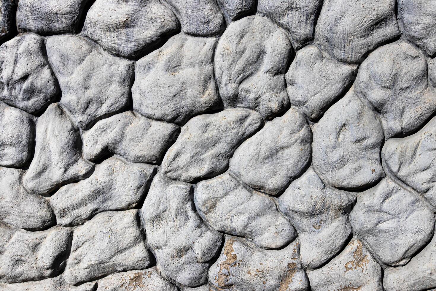 Black and white texture of a wall made of stones. Abstract background. photo