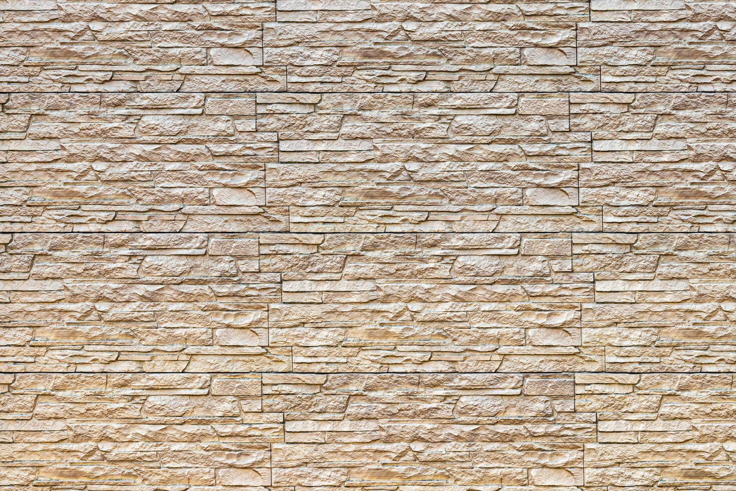 Texture of a wall covered with decorative brick-like tiles. Abstract background for design. photo