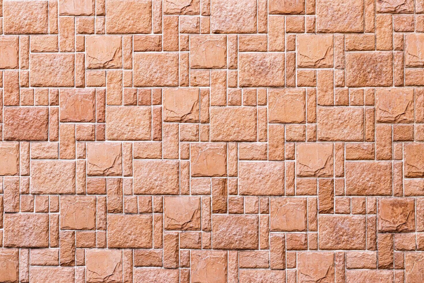 Texture of a wall covered with decorative brick-like tiles. Abstract background for design. photo