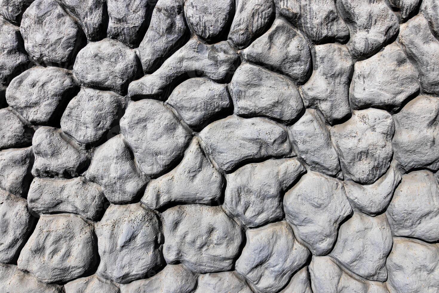 Black and white texture of a wall made of stones. Abstract background. photo