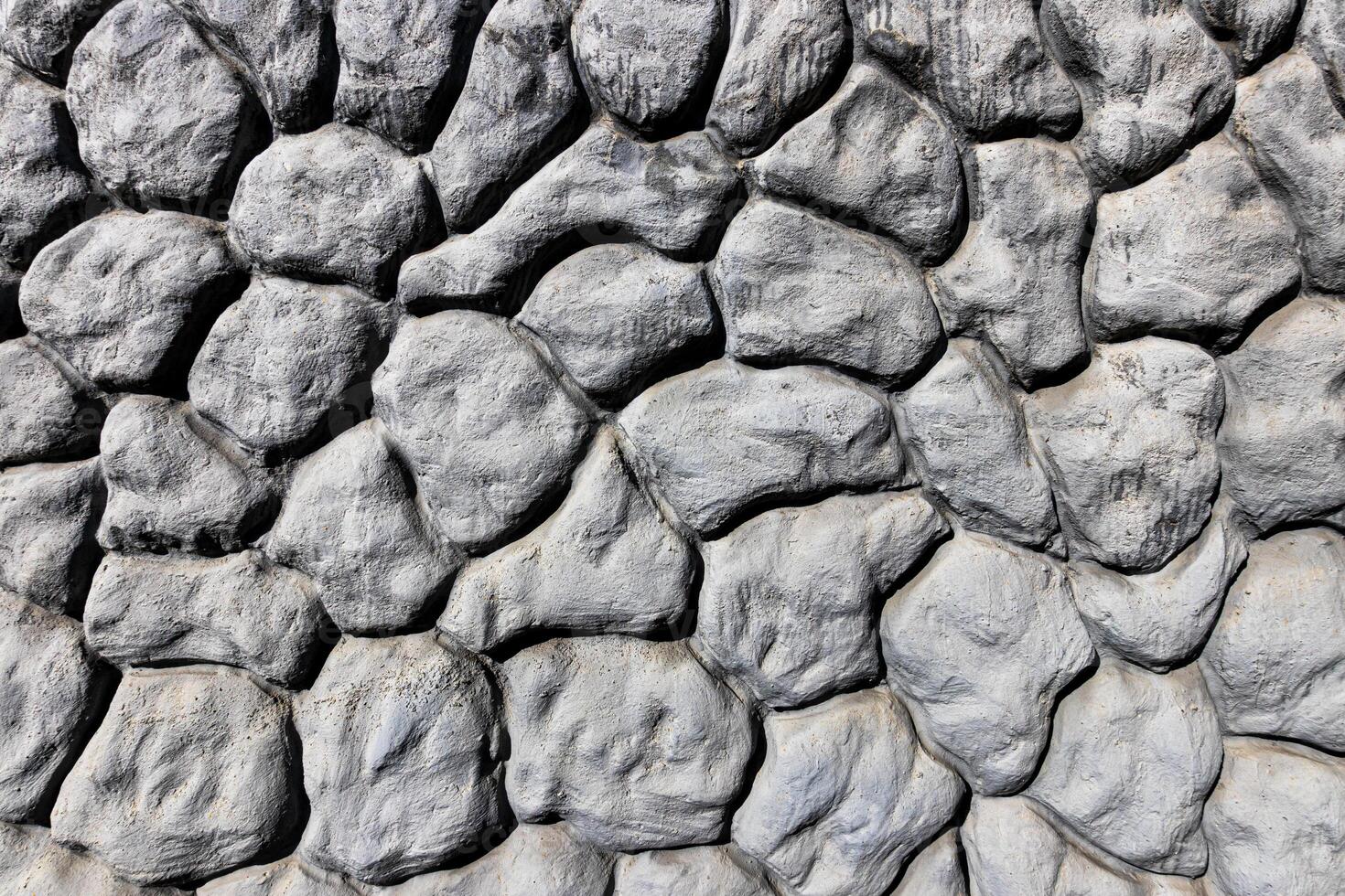 Black and white texture of a wall made of stones. Abstract background. photo