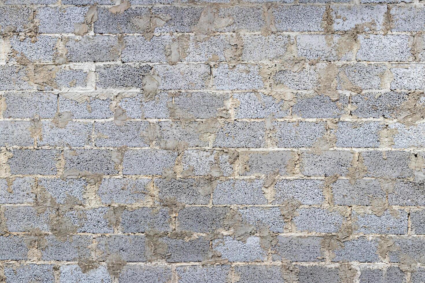 Monochrome texture of a wall made of concrete blocks connected cement. Abstract background. photo