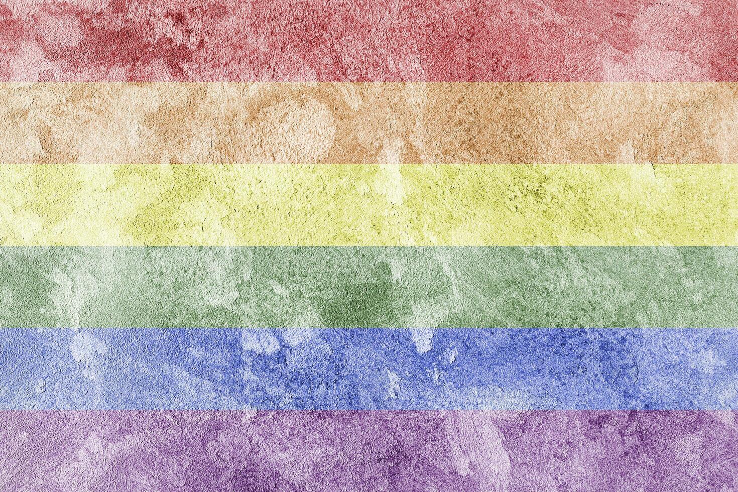 Rainbow LGBTQ or gay pride flag on decorative plaster or concrete texture. Abstract background. photo