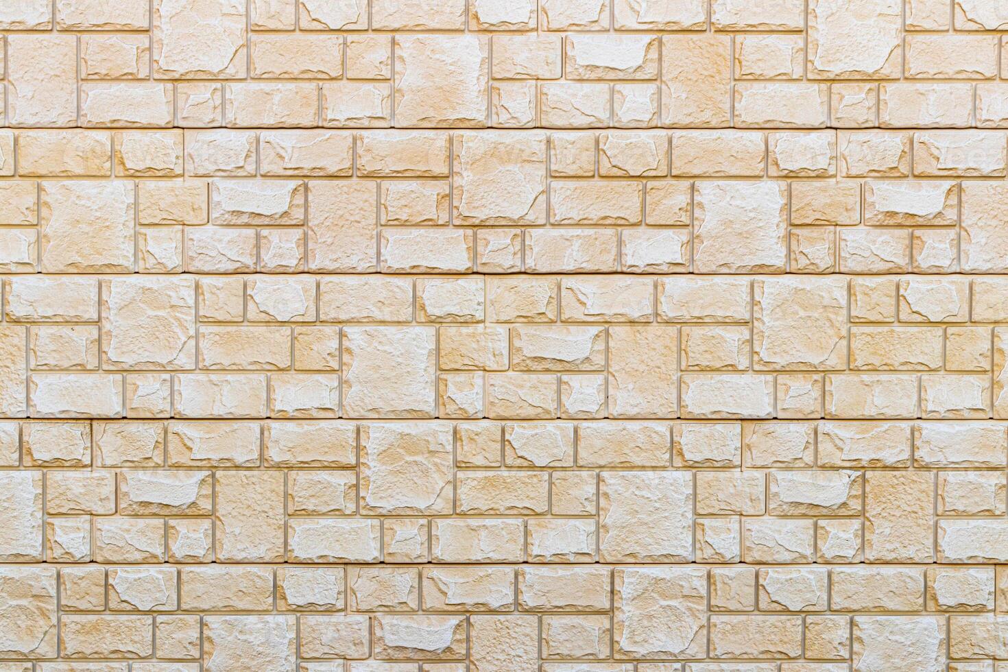 Texture of a wall covered with decorative brick-like tiles. Abstract background for design. photo