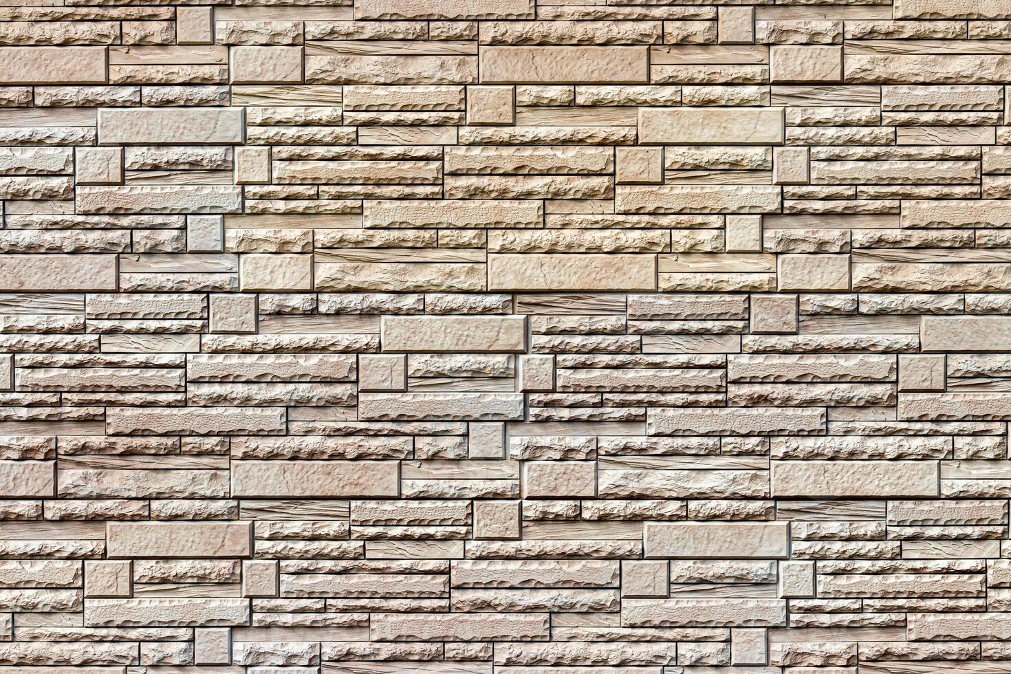 Texture of a wall covered with decorative brick-like tiles. Abstract background for design. photo