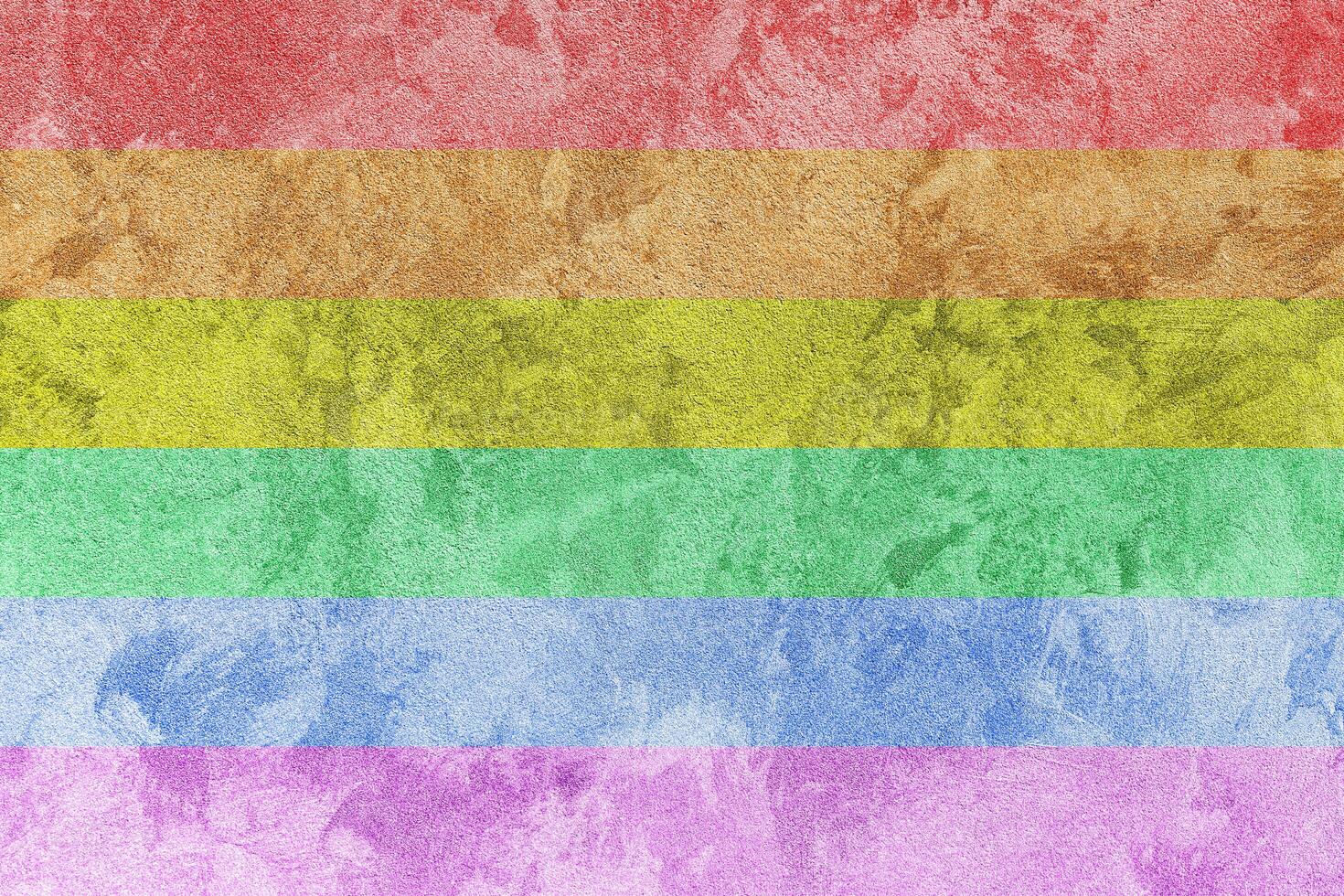 Rainbow LGBTQ or gay pride flag on decorative plaster or concrete texture. Abstract background. photo