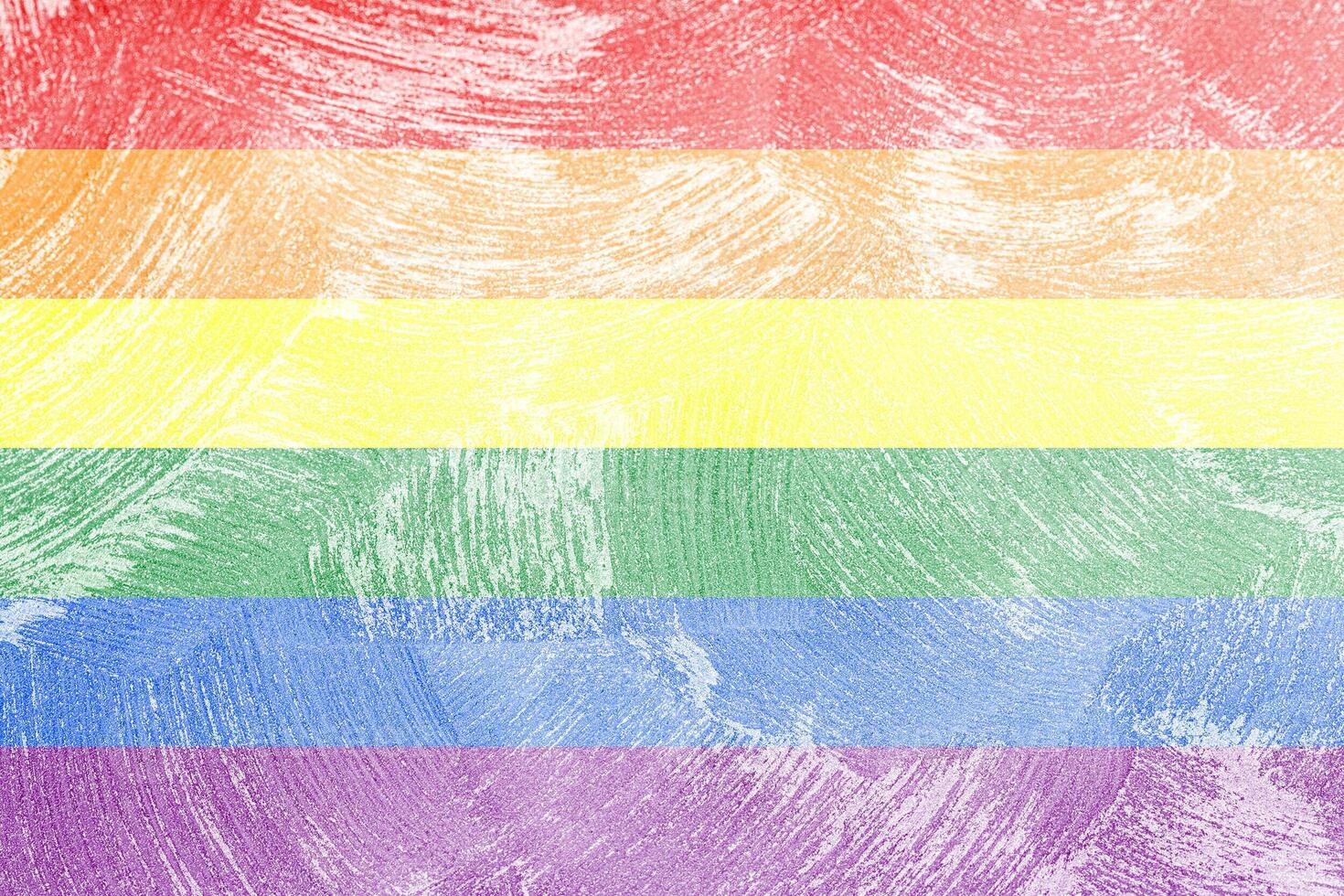 Rainbow LGBTQ or gay pride flag on decorative plaster or concrete texture. Abstract background. photo