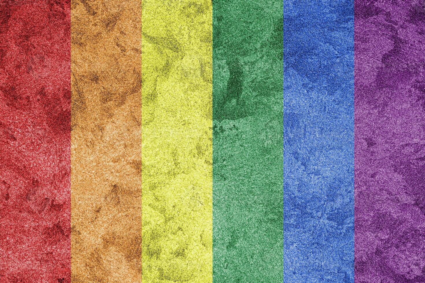 Rainbow LGBTQ or gay pride flag on decorative plaster or concrete texture. Abstract background. photo