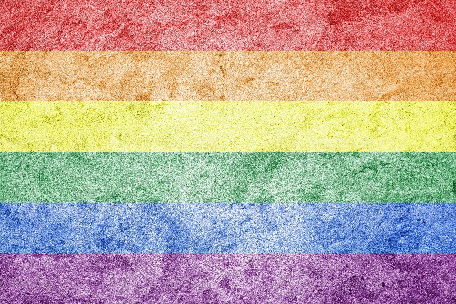 Rainbow LGBTQ or gay pride flag on decorative plaster or concrete texture. Abstract background. photo