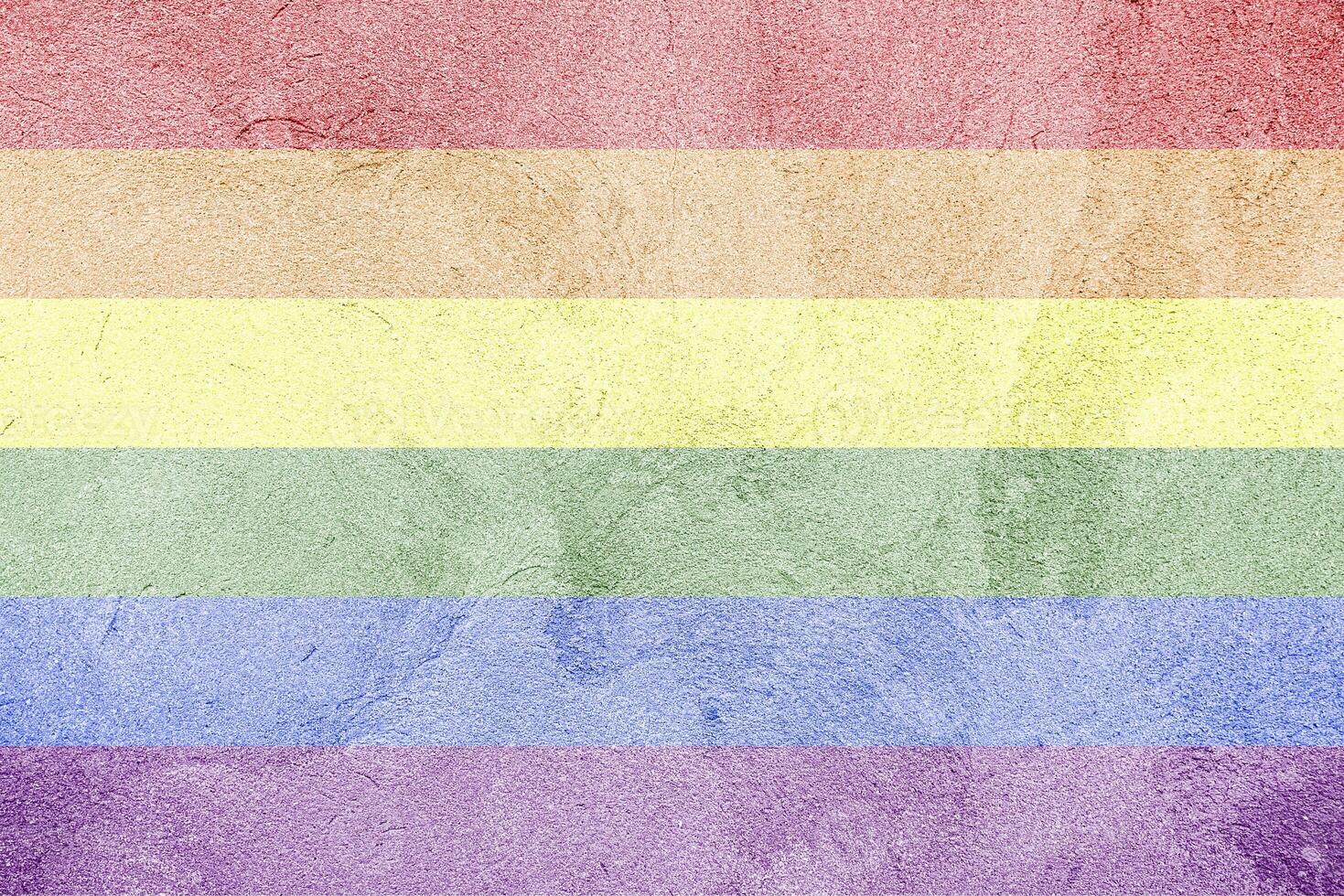 Rainbow LGBTQ or gay pride flag on decorative plaster or concrete texture. Abstract background. photo