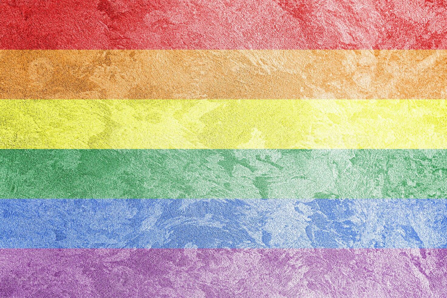 Rainbow LGBTQ or gay pride flag on decorative plaster or concrete texture. Abstract background. photo