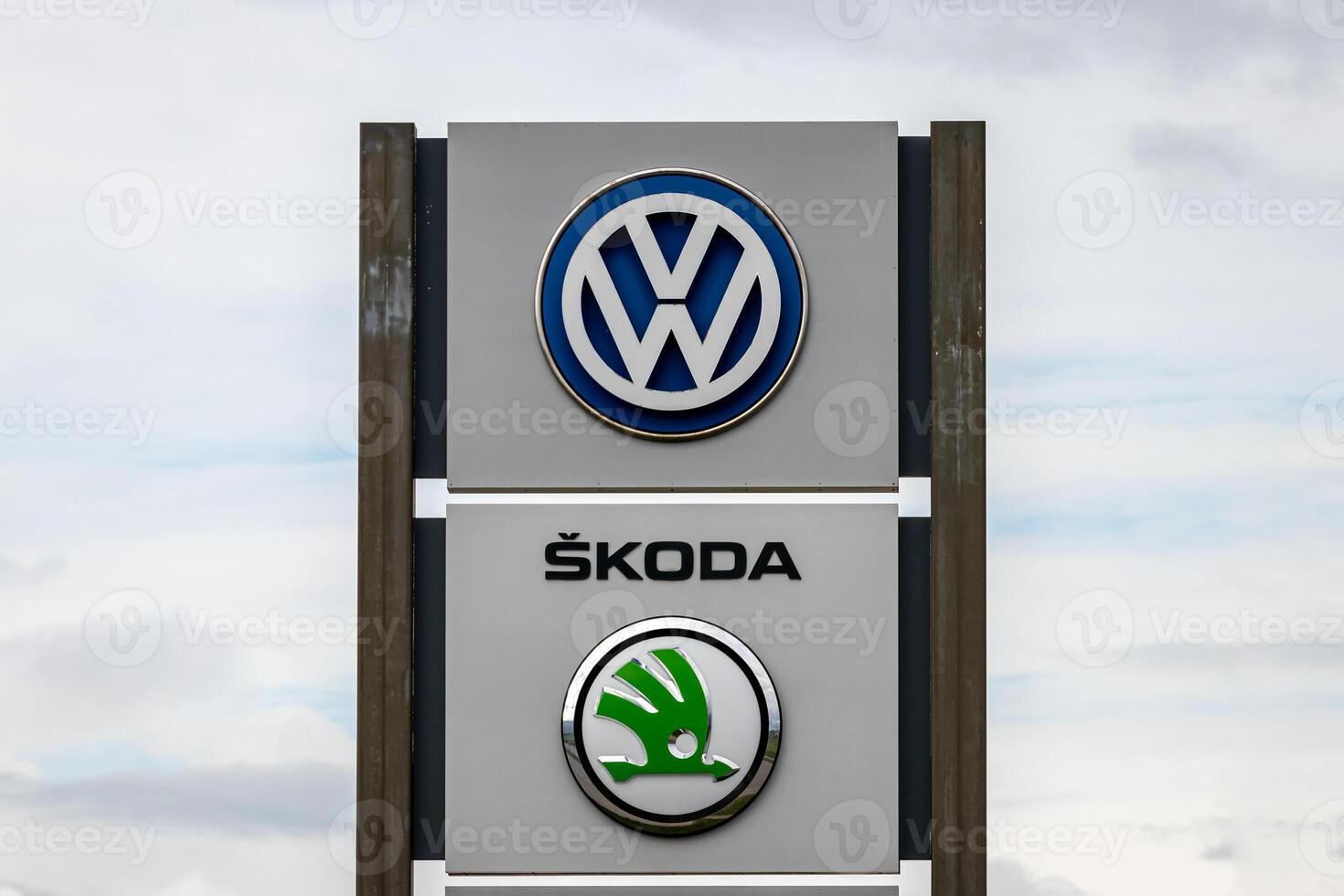 Russia, Kaluga - SEPTEMBER 29, 2020 Metallic Volkswagen and Skoda logos on a stand of a dealership. photo
