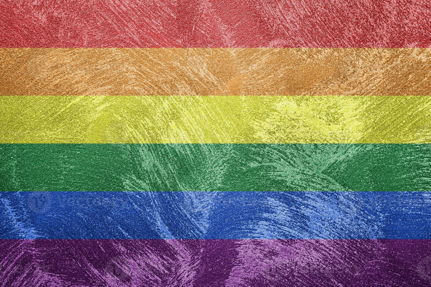 Rainbow LGBTQ or gay pride flag on decorative plaster or concrete texture. Abstract background. photo