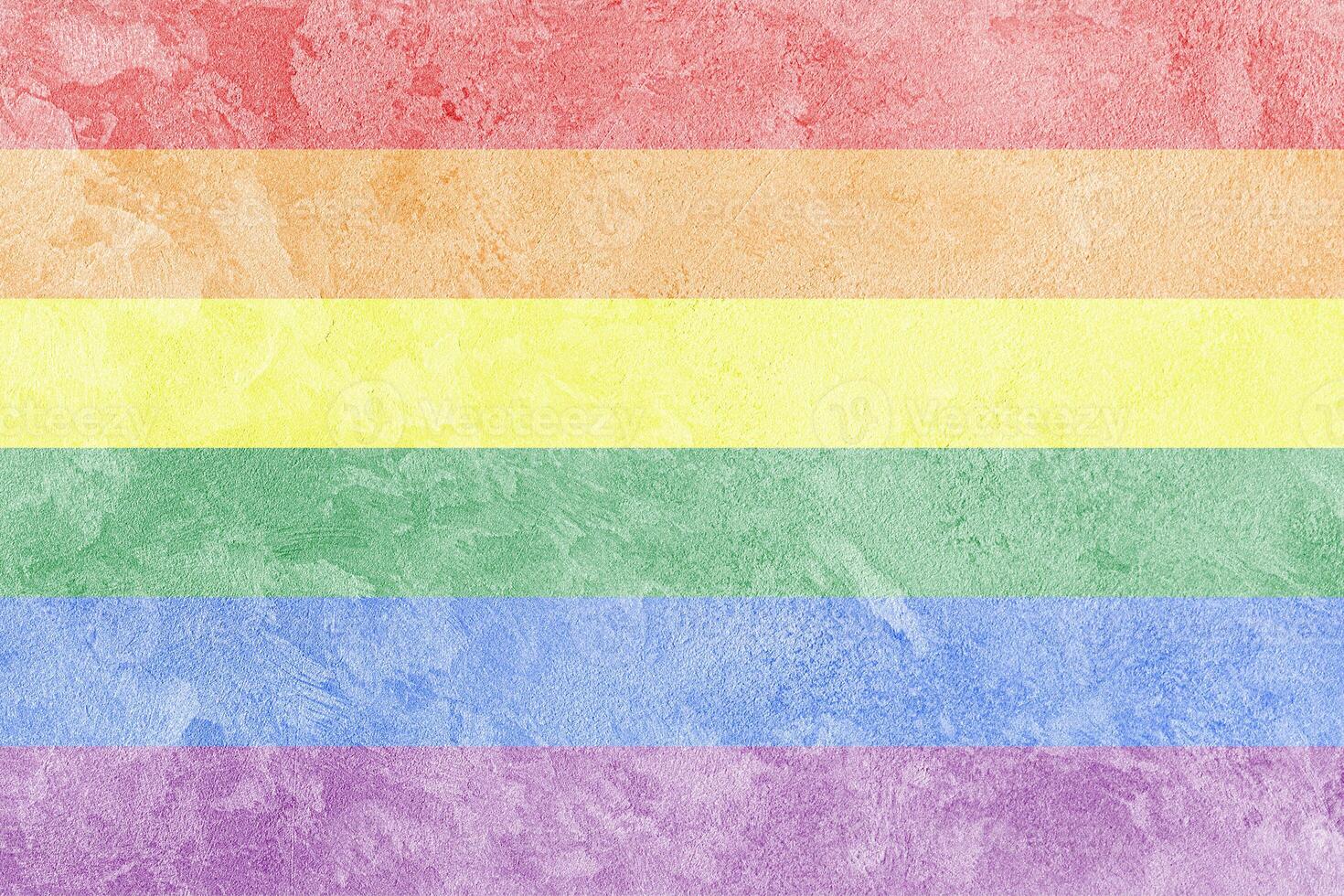 Rainbow LGBTQ or gay pride flag on decorative plaster or concrete texture. Abstract background. photo