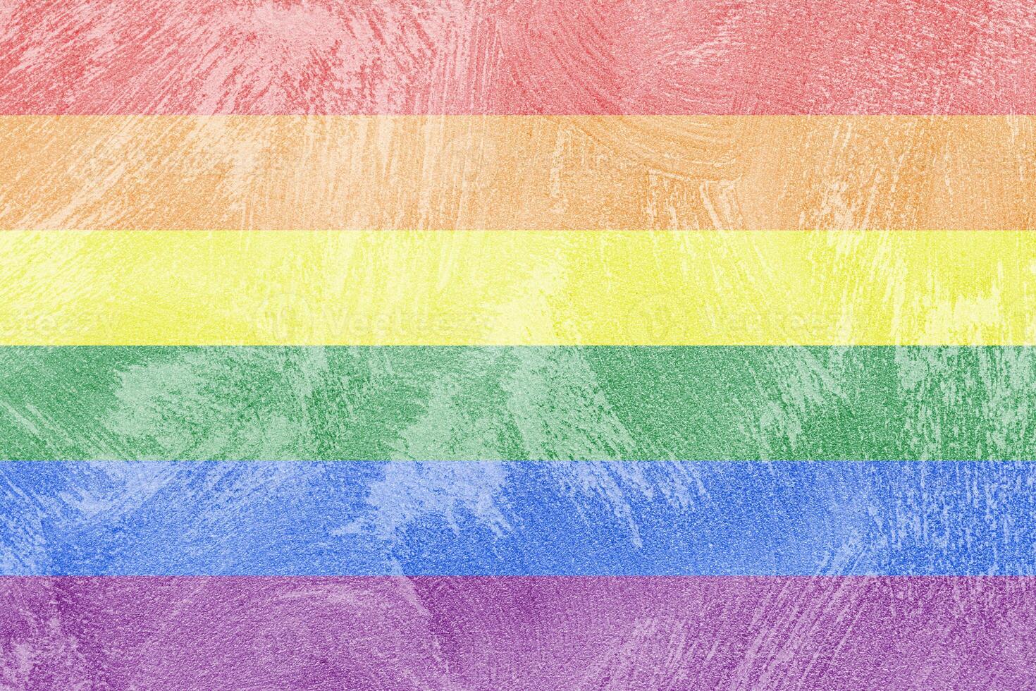 Rainbow LGBTQ or gay pride flag on decorative plaster or concrete texture. Abstract background. photo