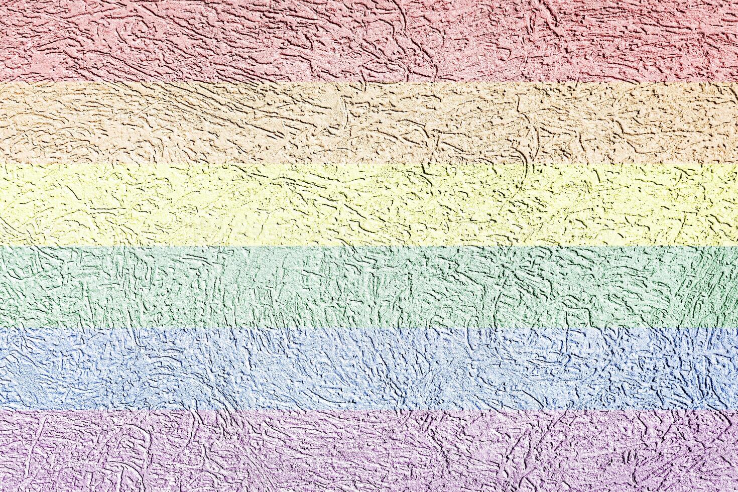 Rainbow LGBTQ or gay pride flag on decorative plaster or concrete texture. Abstract background. photo