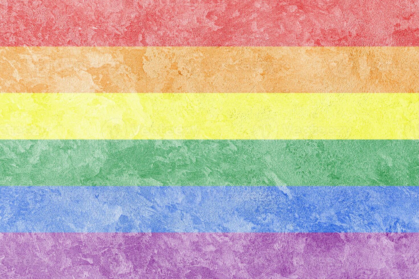 Rainbow LGBTQ or gay pride flag on decorative plaster or concrete texture. Abstract background. photo