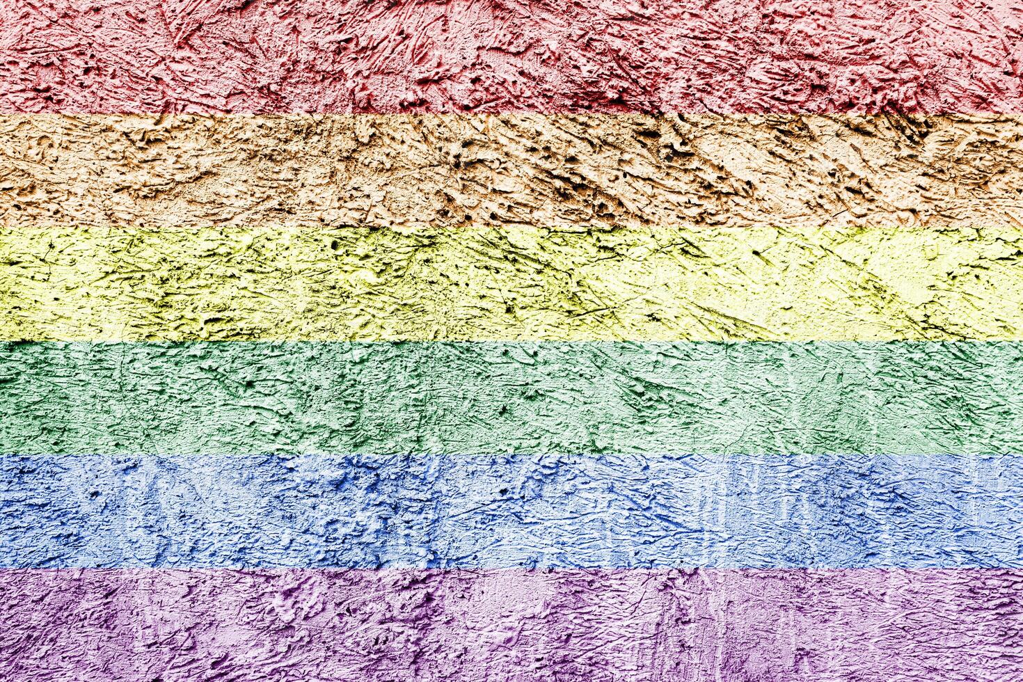 Rainbow LGBTQ or gay pride flag on decorative plaster or concrete texture. Abstract background. photo