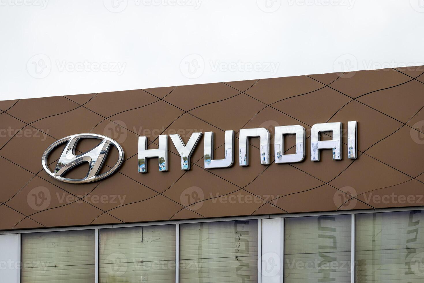 Russia, Kaluga - SEPTEMBER 29, 2020 Metallic Hyundai logo on a roof of a dealership. photo