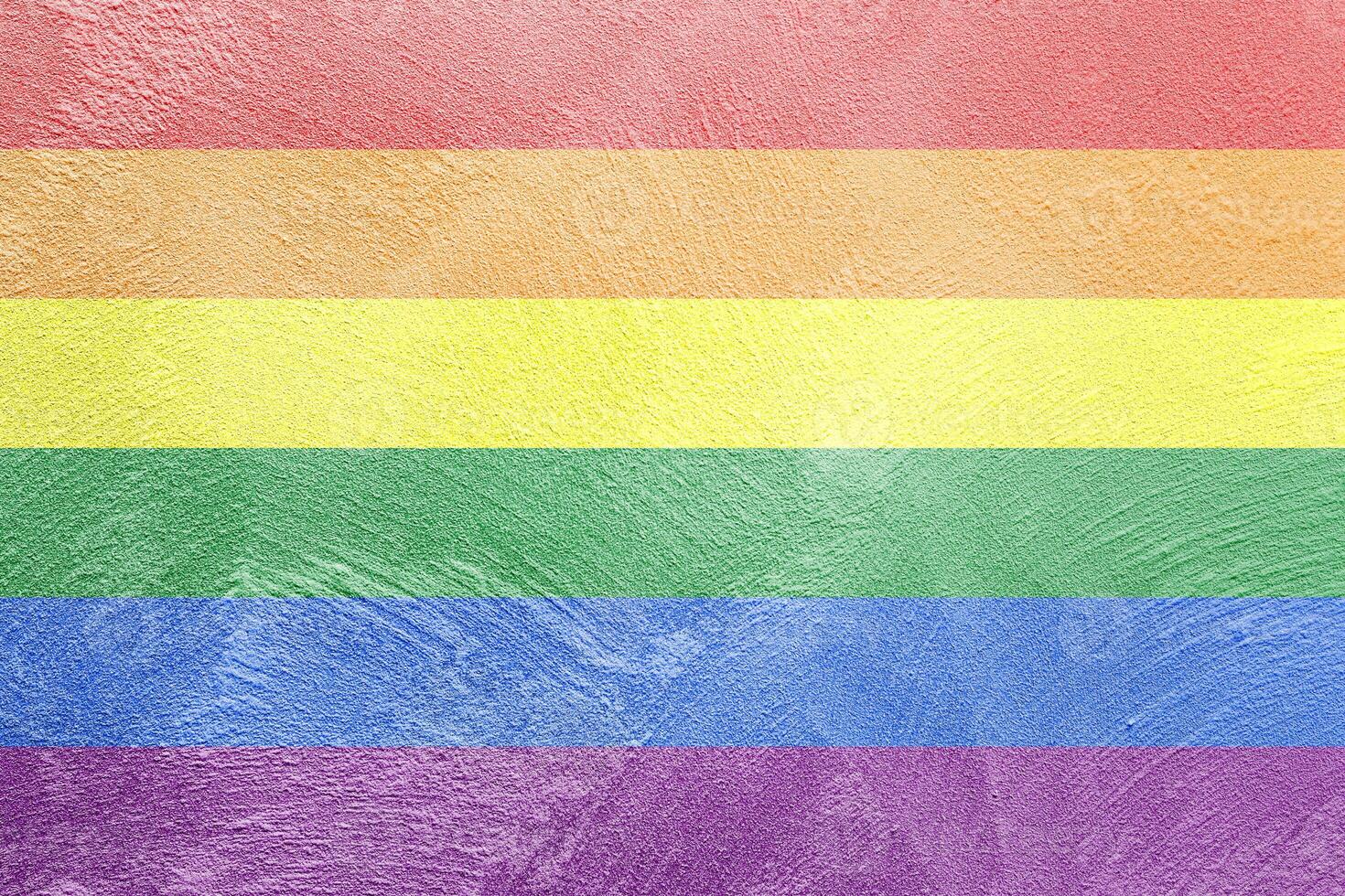 Rainbow LGBTQ or gay pride flag on decorative plaster or concrete texture. Abstract background. photo