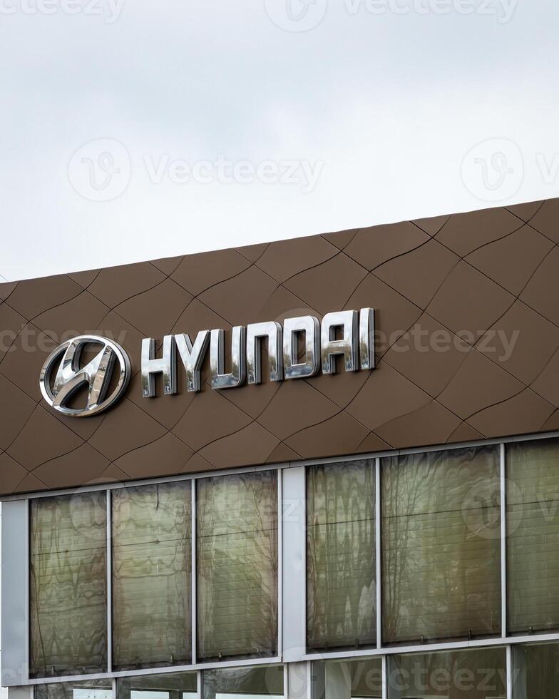 Russia, Kaluga - SEPTEMBER 29, 2020 Metallic Hyundai logo on a roof of a dealership. photo