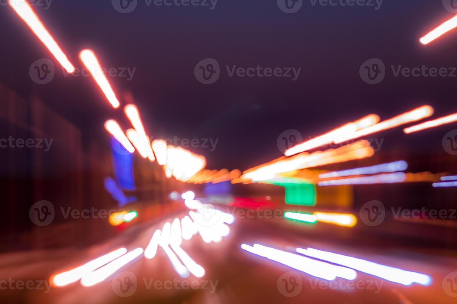 Traces of headlights from cars moving at night on the bridge, illuminated by lanterns. Abstract blured defocused city landscape with highway. photo