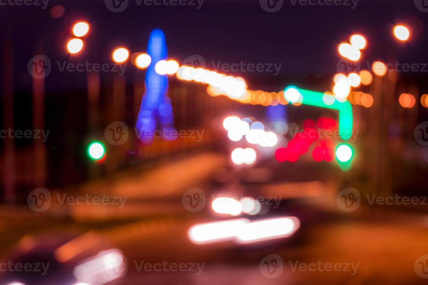 Traces of headlights from cars moving at night on the bridge, illuminated by lanterns. Abstract blured defocused city landscape with highway. photo