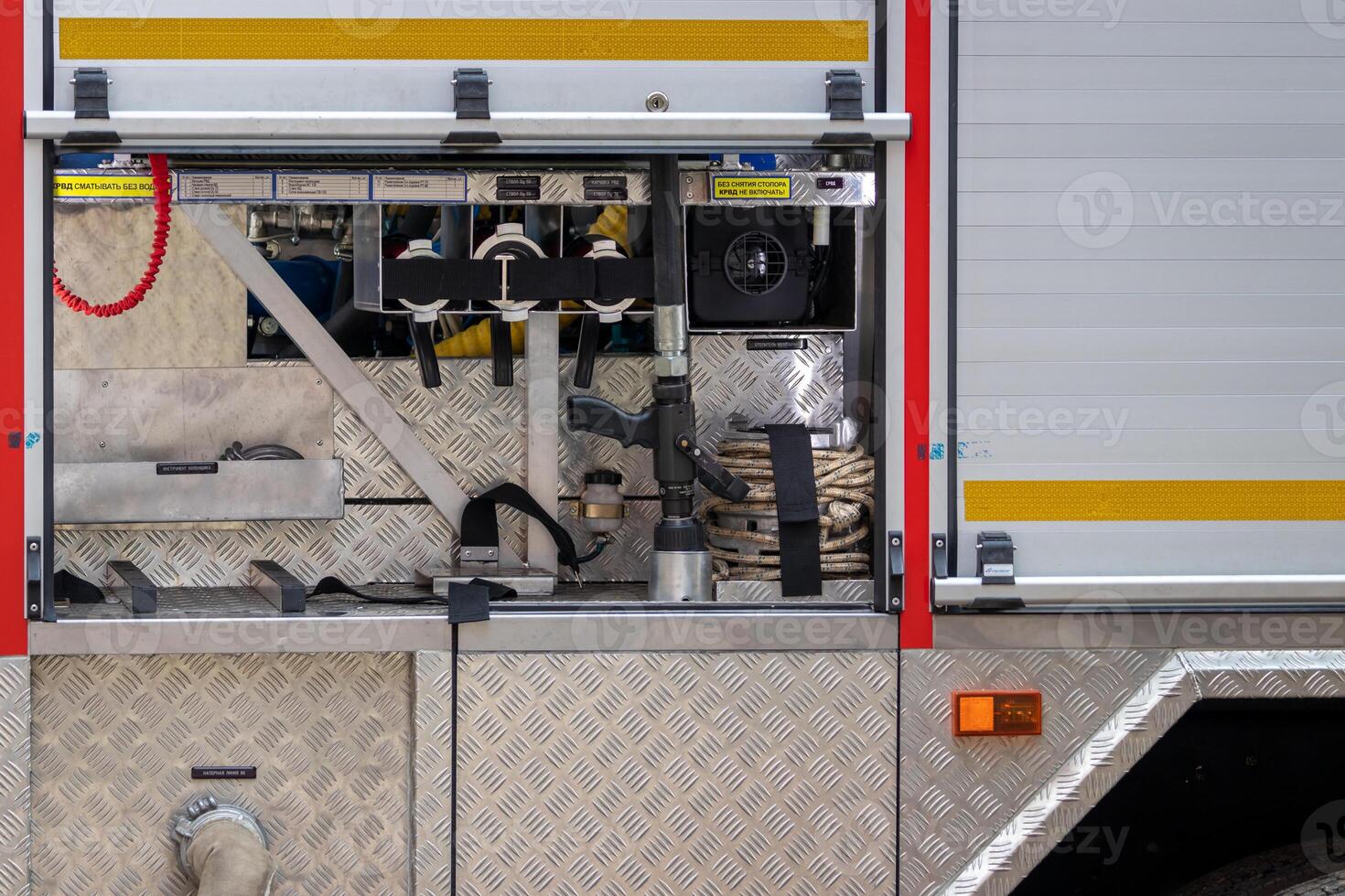Rescue equipment of a fire engine with inscriptions in Russian. Pumps and hoses . photo