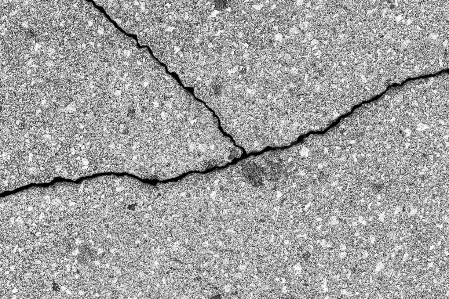 Cracked texture of gray asphalt. Abstract background. photo
