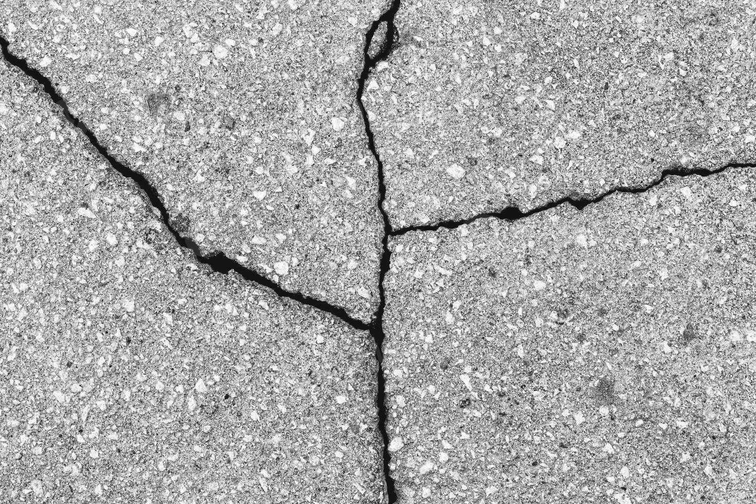 Cracked texture of gray asphalt. Abstract background. photo
