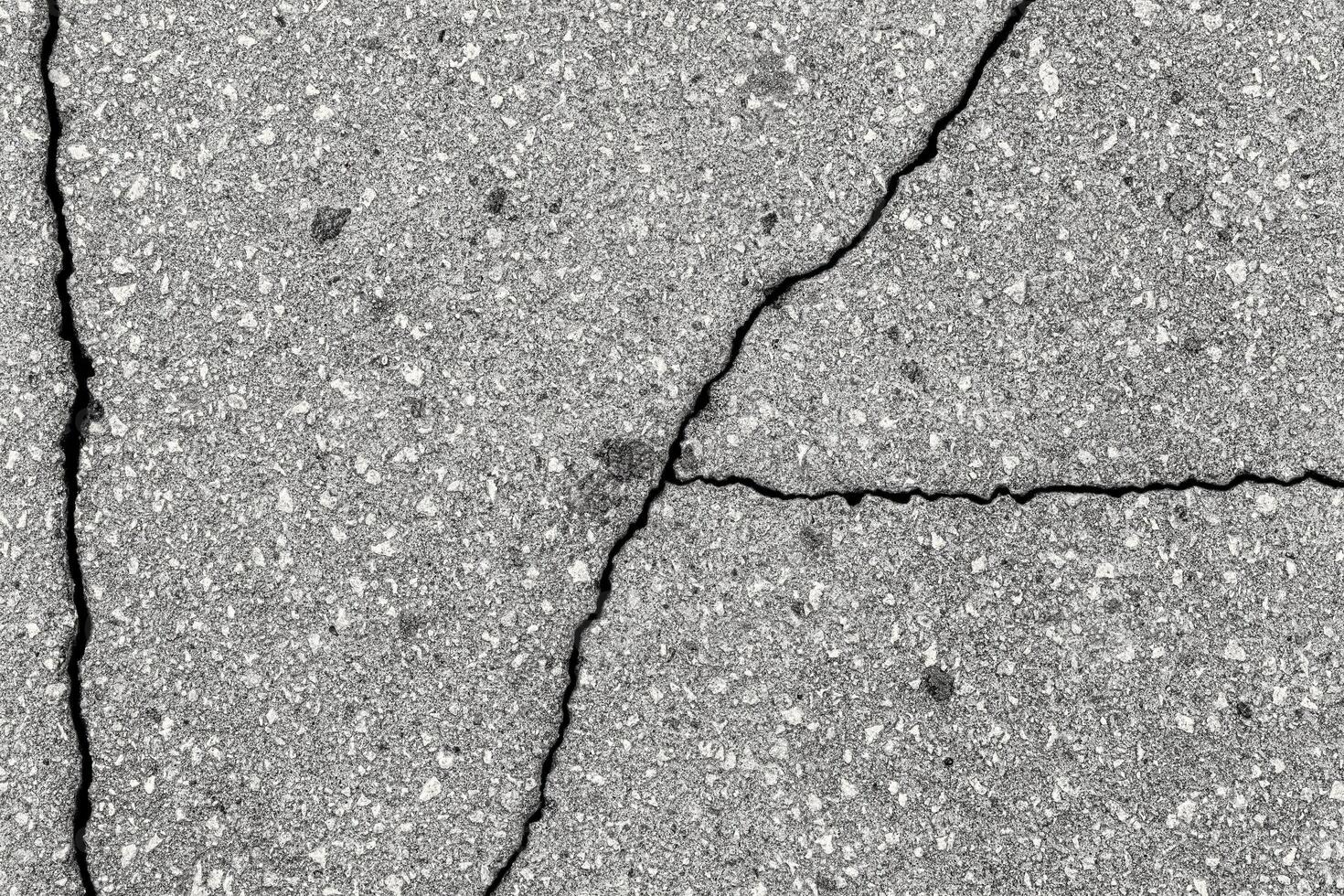 Cracked texture of gray asphalt. Abstract background. photo